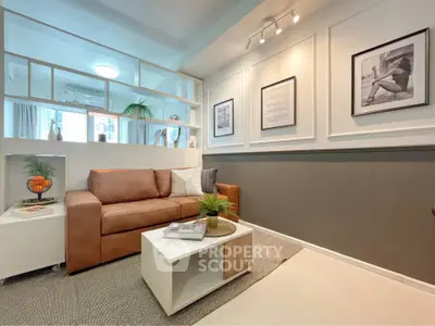 Stylish living room with modern decor and cozy seating in a contemporary apartment.