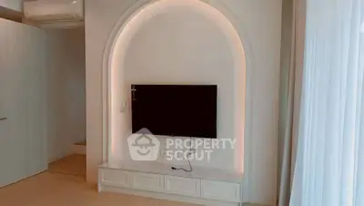 Modern living room with built-in TV alcove and soft lighting