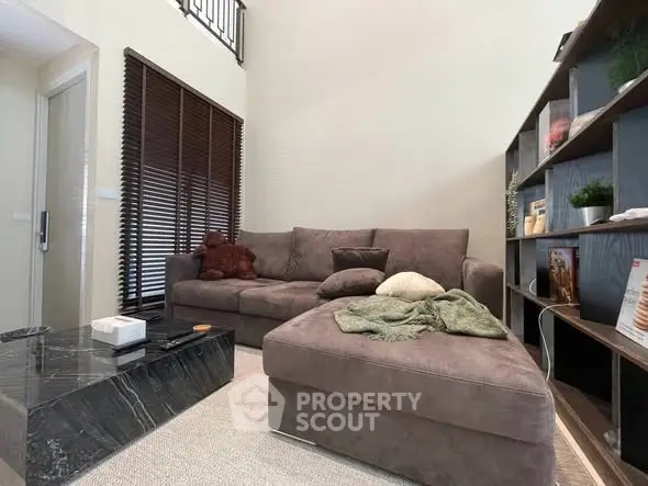 Cozy living room with plush sofa and modern decor, perfect for relaxation and entertainment.