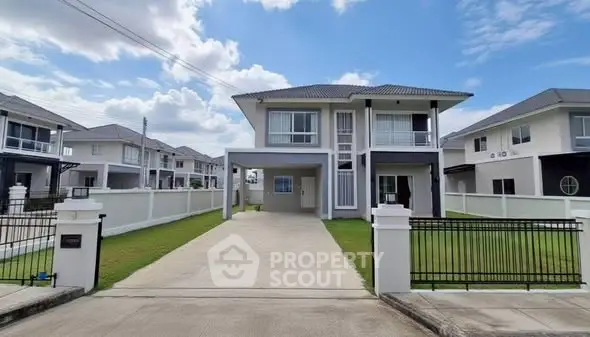 Modern two-story house with spacious driveway and manicured lawn in suburban neighborhood.