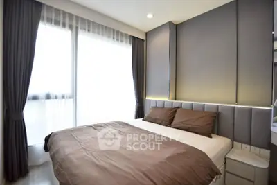 Modern bedroom with stylish decor and large window for natural light