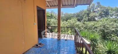 Charming balcony with lush green views and rustic design, perfect for relaxation and enjoying nature.