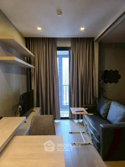 Modern living room with sleek furniture and large window offering city view.