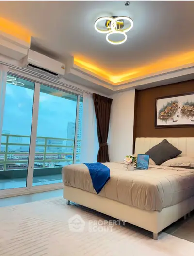 Luxurious bedroom with modern lighting and balcony view in high-rise apartment