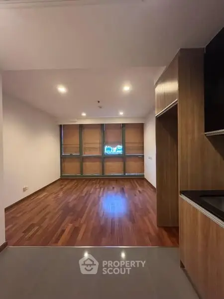 Spacious modern living room with wooden flooring and large windows