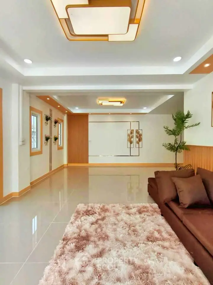 Spacious modern living room with elegant lighting and plush carpet