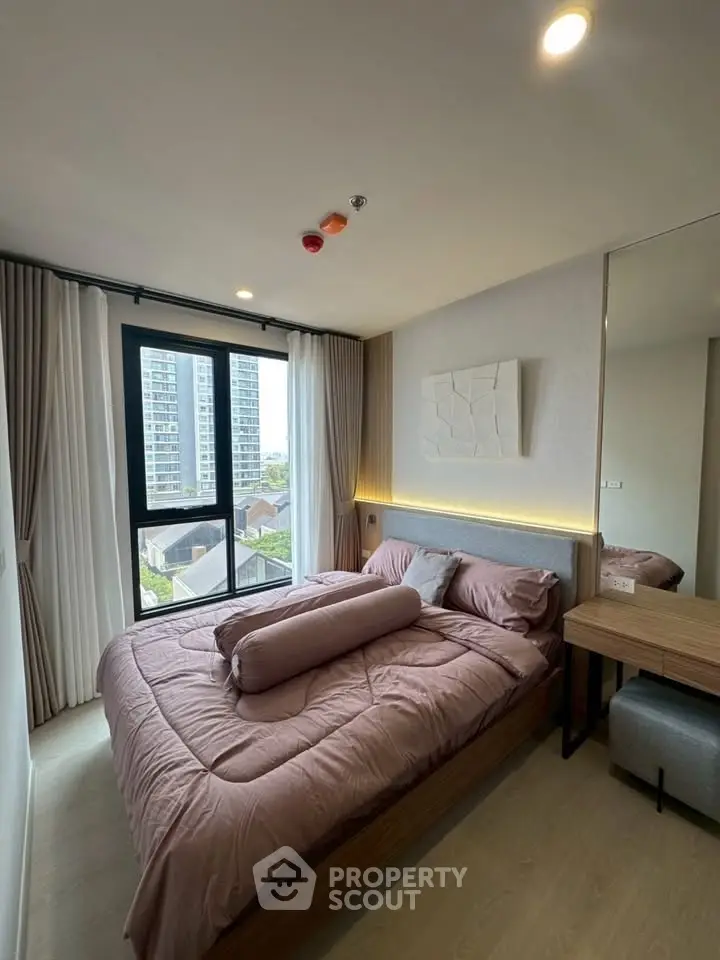 Modern bedroom with large window and stylish decor in urban apartment