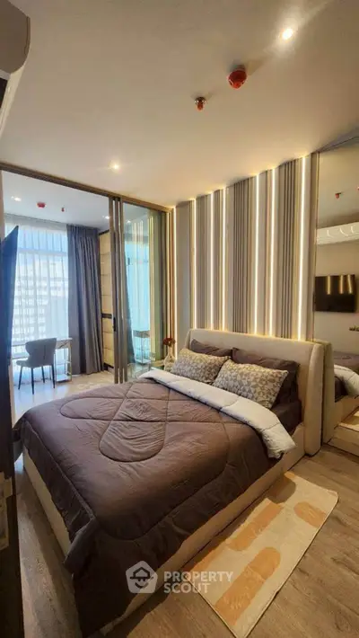 Luxurious modern bedroom with stylish lighting and large windows offering city views.