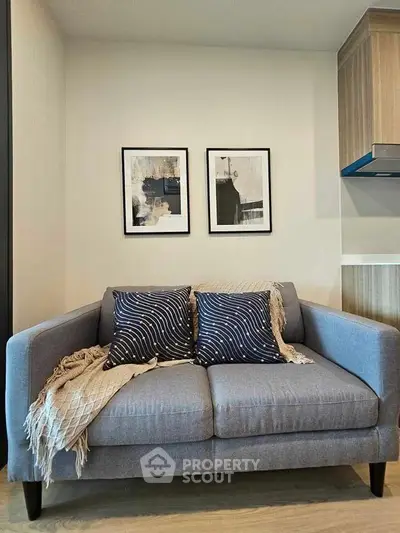 Stylish modern living room with cozy gray sofa and chic wall art