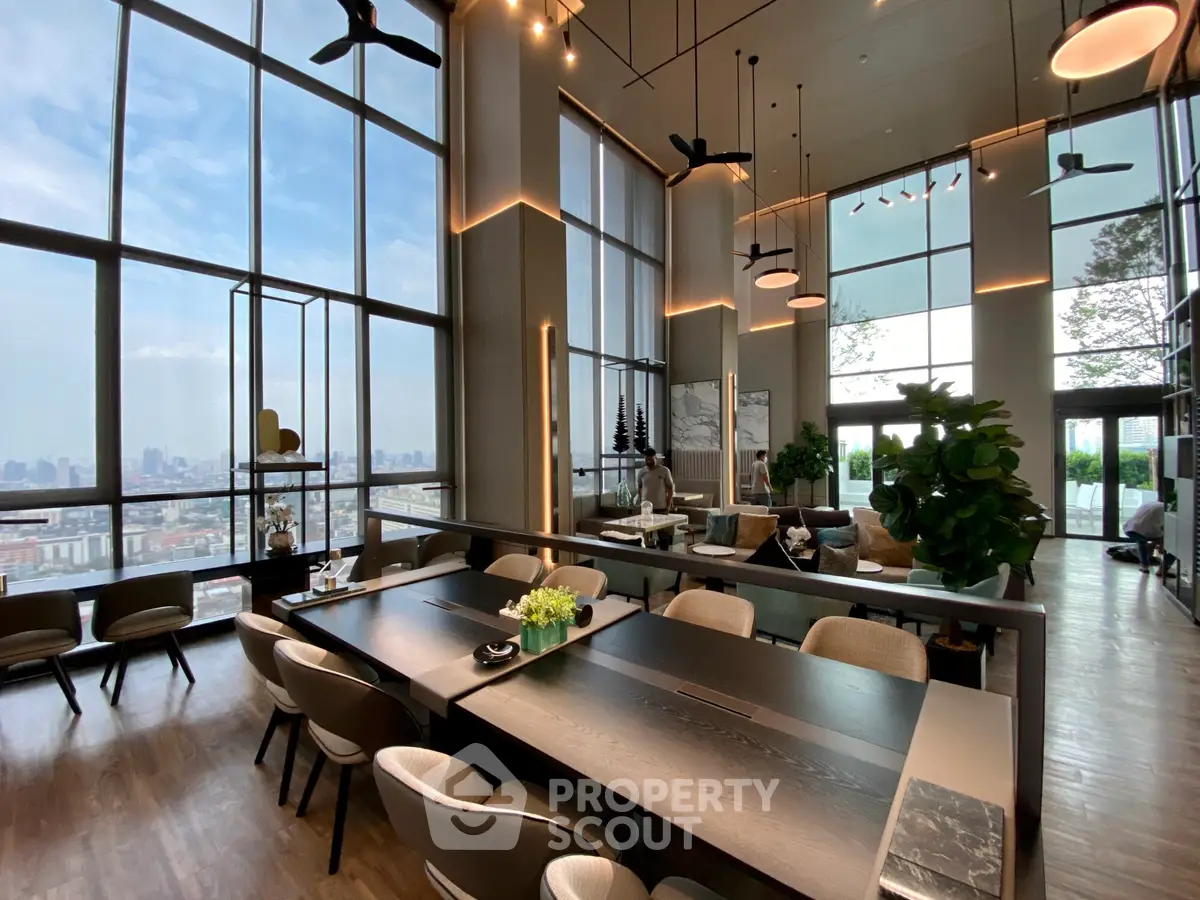 Luxurious high-rise living room with panoramic city views and modern decor.