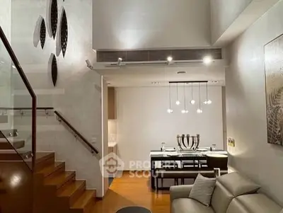 Modern living room with elegant dining area and stylish staircase