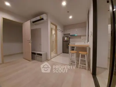 Modern open-layout apartment with sleek kitchen and cozy living space