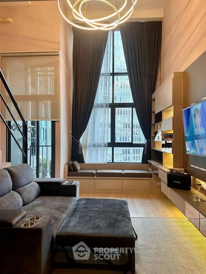 Modern living room with high ceilings and large windows in urban apartment