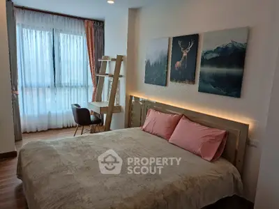 Cozy bedroom with large window and stylish decor in modern apartment