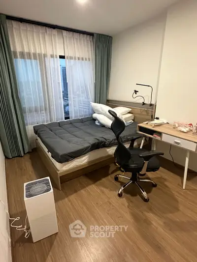Modern bedroom with city view, featuring sleek furniture and cozy ambiance.