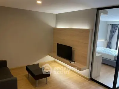 Modern living room with sleek TV setup and wooden flooring