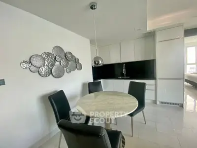 Modern kitchen with sleek design, marble table, and stylish chairs in a contemporary apartment.