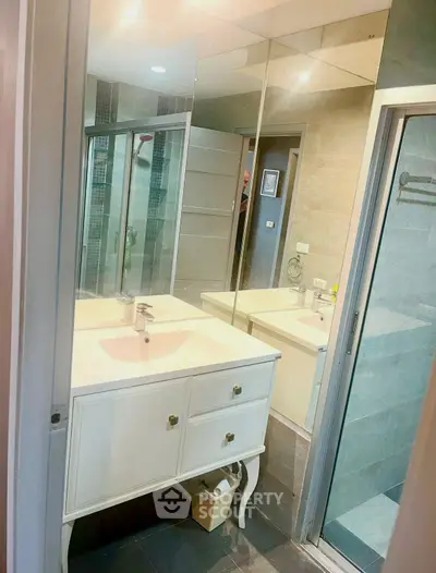 Modern bathroom with elegant vanity and glass shower enclosure