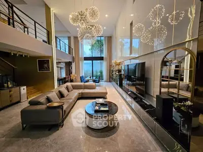 Luxurious modern living room with high ceilings, elegant lighting, and spacious seating area.