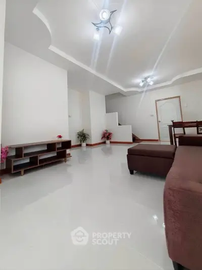 Spacious modern living room with sleek design and elegant lighting