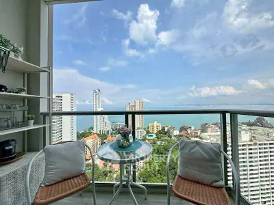 Stunning high-rise balcony with panoramic ocean and city views, perfect for relaxation.