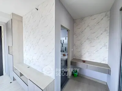 Modern interior with marble accent wall and built-in storage in a bright room