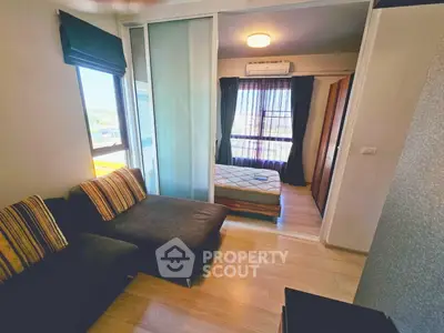 Cozy apartment with sliding glass doors, modern furnishings, and natural light.