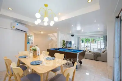 Spacious open-plan living room with pool table and dining area