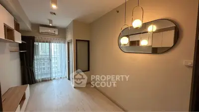 Modern living room with elegant lighting and balcony view in urban apartment.