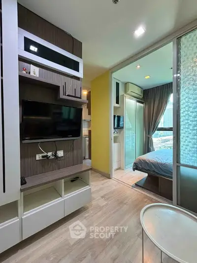 Modern apartment interior with stylish living room and cozy bedroom, featuring sleek design and natural light.