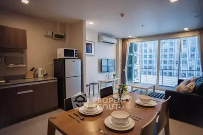 Modern open-plan living room with kitchen and balcony view