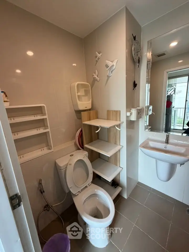 Modern bathroom with sleek fixtures and wall-mounted storage solutions.