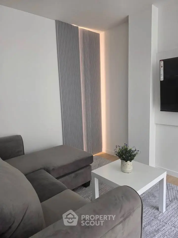 Modern living room with sleek grey sofa and stylish decor