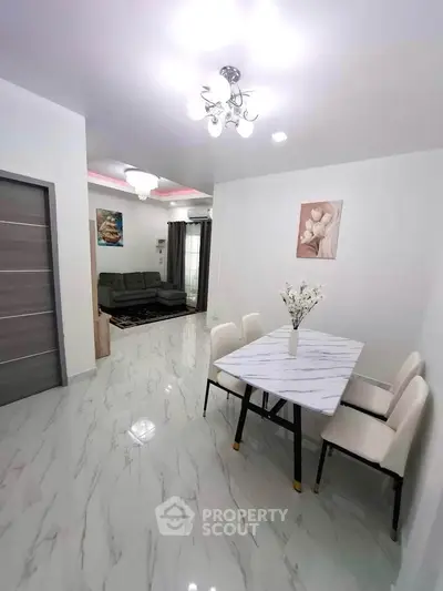 Modern dining and living area with elegant marble flooring and stylish decor