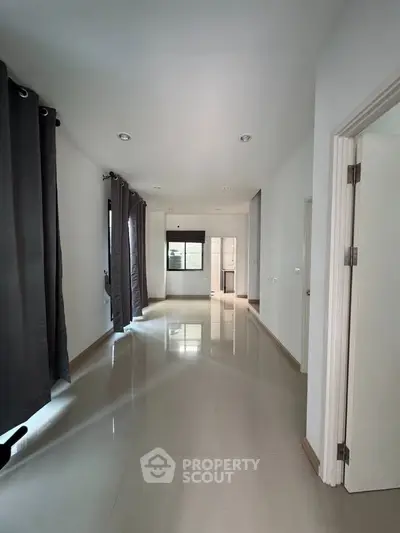 Spacious hallway with modern design and natural light in a contemporary home.