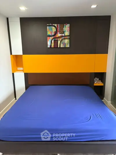 Modern bedroom with colorful wall art and sleek design