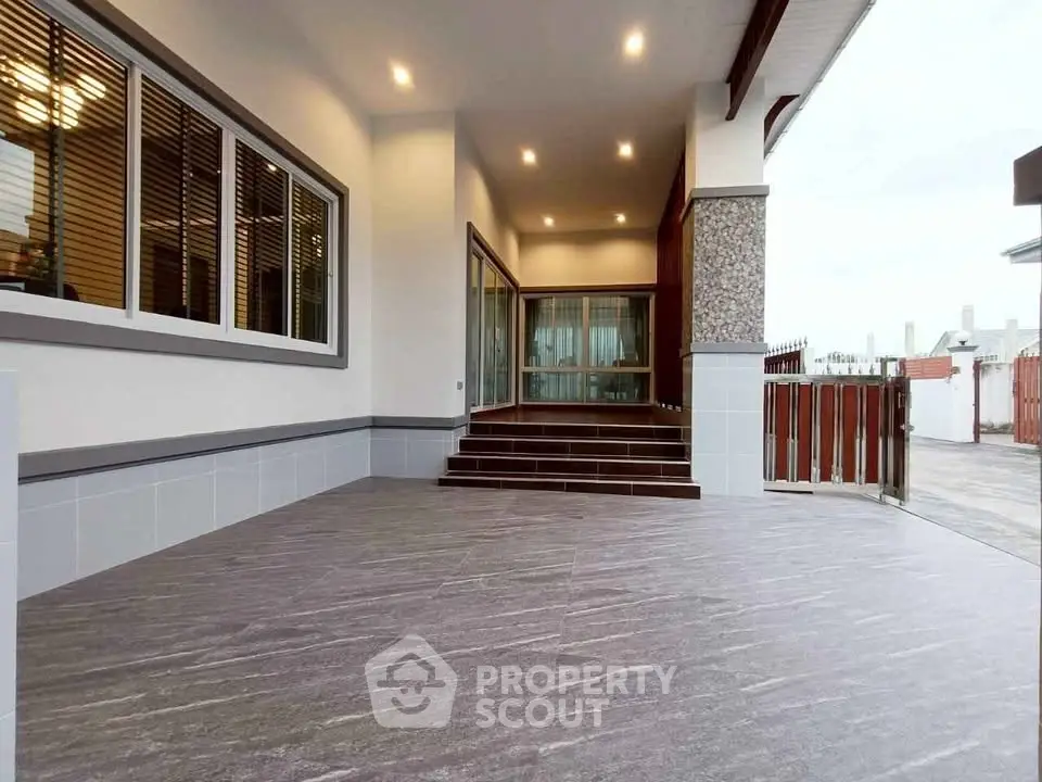 Spacious modern entrance with elegant tile flooring and ambient lighting.