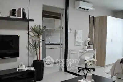 Modern studio apartment with sleek furniture and open kitchen layout.