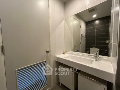 Modern bathroom with sleek design and large mirror