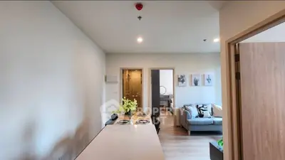 Modern open-plan living room with dining area and cozy seating, perfect for urban living.