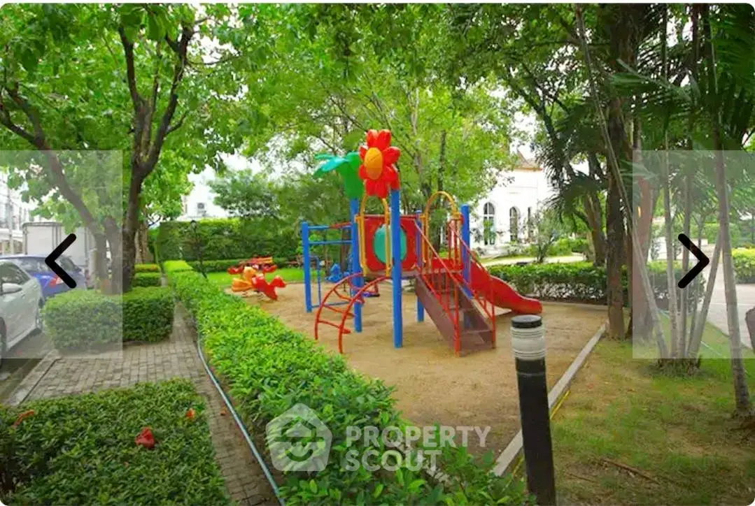 Charming residential playground surrounded by lush greenery, perfect for family-friendly living.