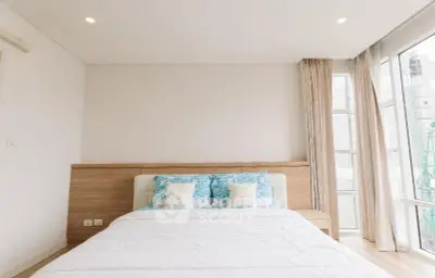 Bright and airy bedroom with large windows and modern decor
