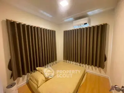 Cozy bedroom with air conditioning and elegant curtains, perfect for restful nights.