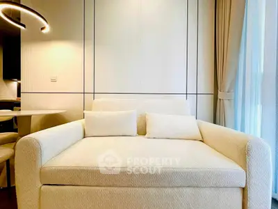 Modern living room with stylish sofa and elegant lighting, perfect for cozy relaxation.