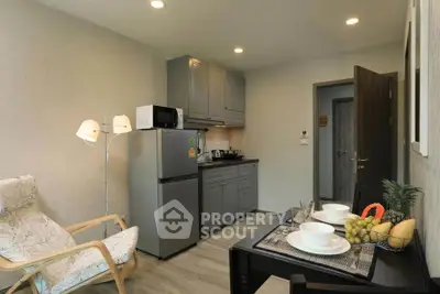 Cozy kitchen with modern appliances and dining setup in a stylish apartment.