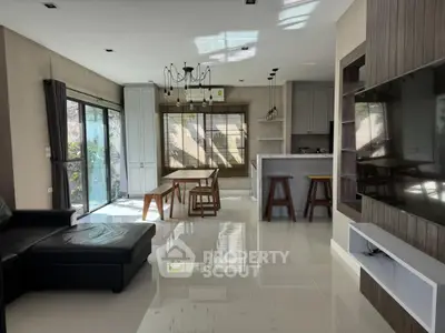 Spacious modern living room with open kitchen and natural light