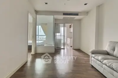 Spacious modern living room with hardwood floors and natural light