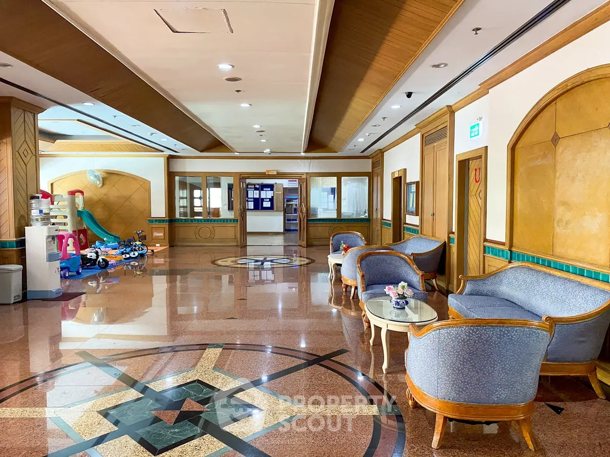 Luxurious building lobby with elegant seating and children's play area, showcasing exquisite design and comfort.
