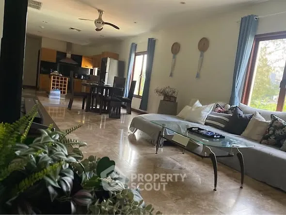 Spacious living room with modern decor and large windows for natural light.