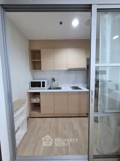 Modern compact kitchen with sleek cabinetry and appliances